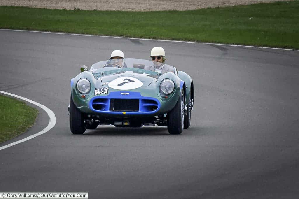 the late sir stirling moss driving a 1956/57 aston martin dbs 3 sports racing car at the goodwood revival meeting