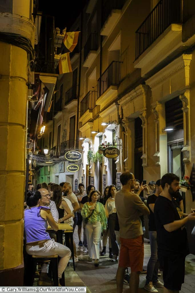 a busy lane in zaragoza's old town filled with people enjoying tapas