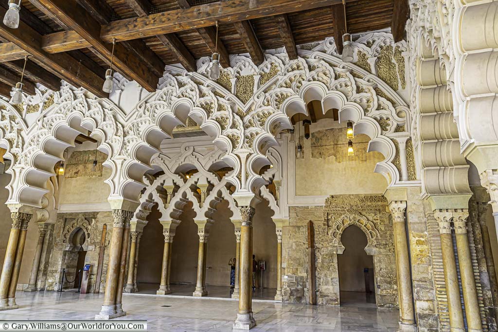 the ornately decorated mudéjar arches of the moorish-taifa north side hall within the aljafería palace in zaragoza, spain