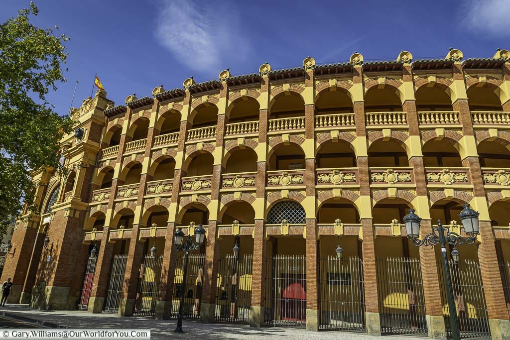 the red brick stone work with contrasting arches of the exterior of the circular bull ring in zaragoza, spain
