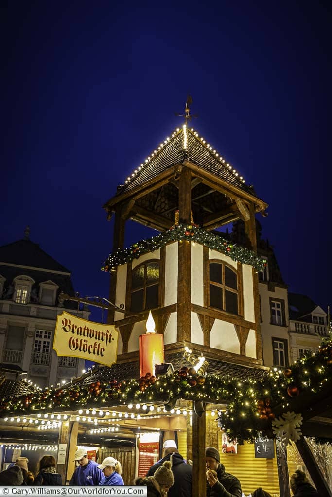 The illuminated wooden tower above the sausage stall in triers hauptmarkt geman christmas market at dusk