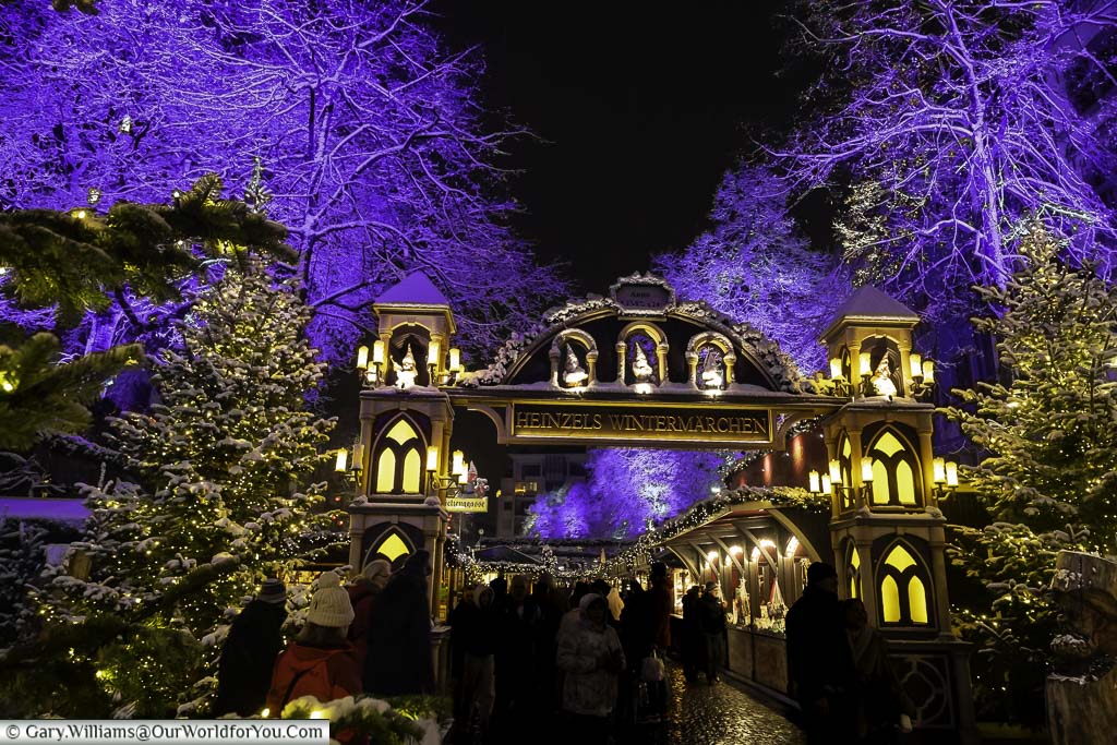 One entrance to Heinzels Wintermarchen german christmas market in cologne on a snowy winters evening