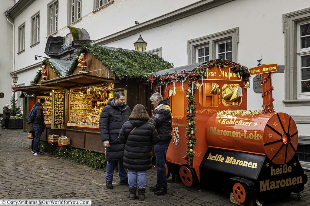 A stream-train themed chestnut roaster in the jesuitenplatz christmas market in koblenz