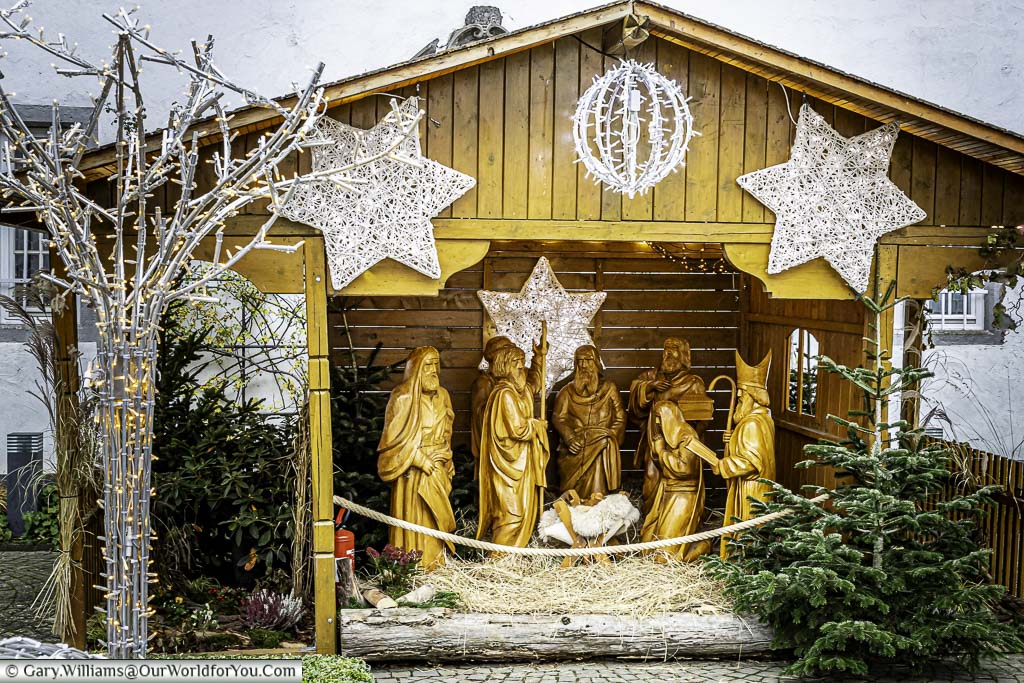 The nativity scene with caved wooden figures in a small hut in willi-hörter-platz in the koblenz, germany