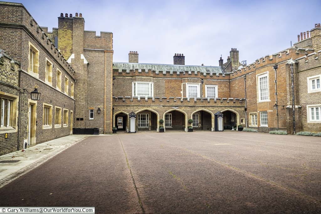 The empty open space of Friary Court surrounded on 3 sides by wings of St James’s Palace