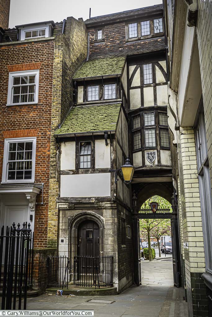The view through the medieval saint bartholomew-the-great gatehouse, leading towards smithfield in the city of london