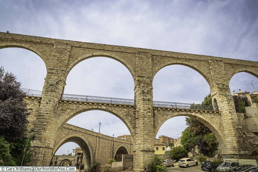 A street-level view of the three brick-built stone coloured aqueducts of teruel, spain