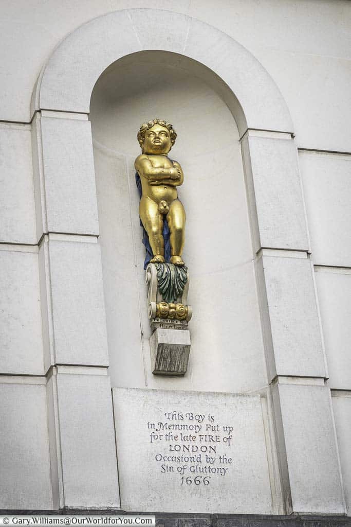 A statue of the golden boy of pye corner on the edge of giltspur street and cock lane in the smithfield region of the city of london