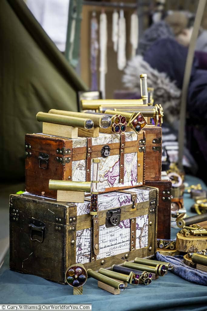 some travel curios on a stack of chests on a stall at the historic greenwich market in south east london