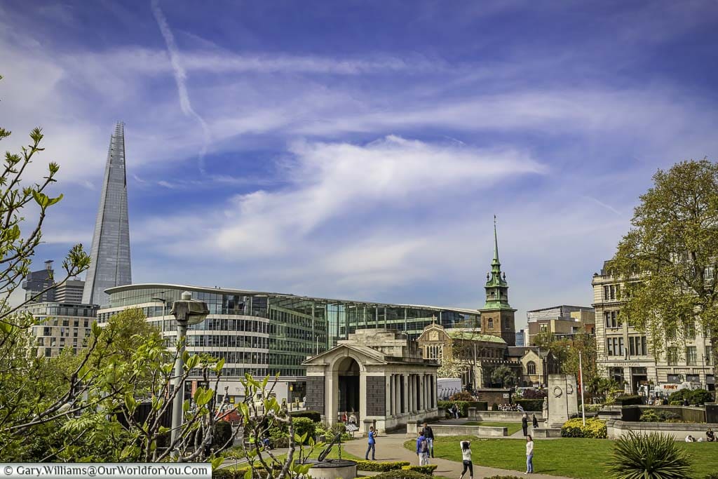 A view across Trinity Memorial Gardens in London, with the tower of All Hallows by the Tower church and The Shard in the distance.