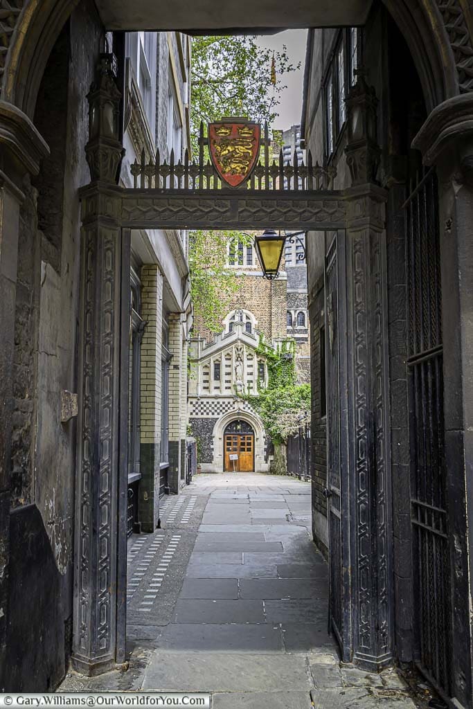 The view through the medieval saint bartholomew-the-great gatehouse, leading to the saint bartholomew-the-great church in the historic smithfield region of the city of london