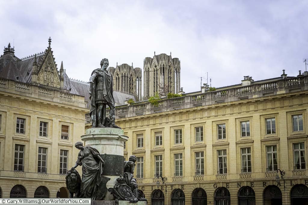 A brass statue to louis XV in the centre of place royale in reims in the champagne region of france