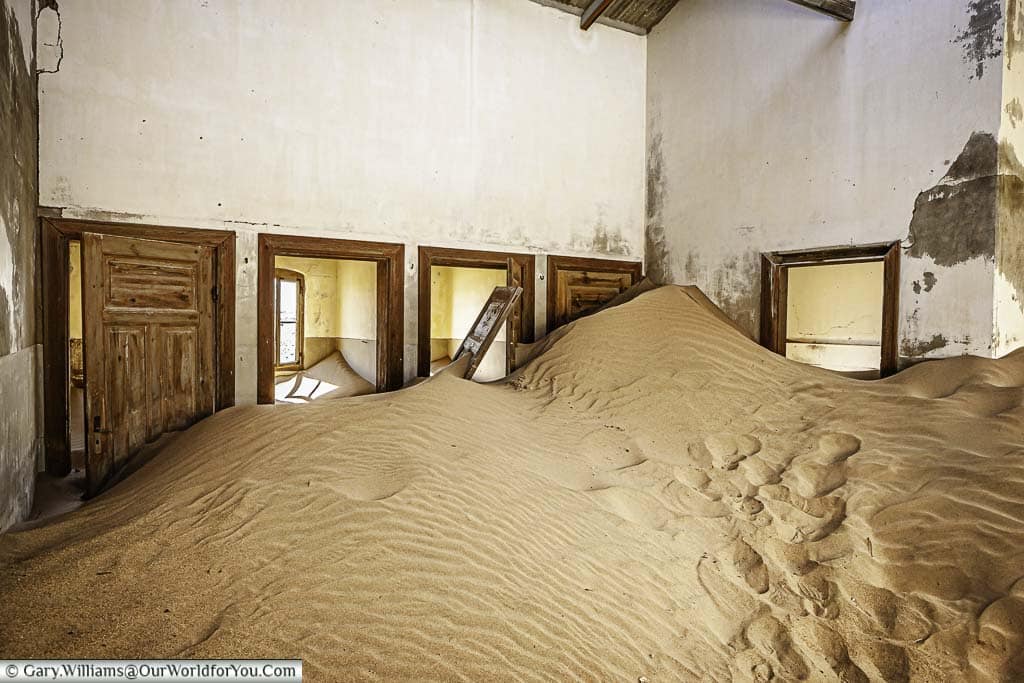 Sand dunes inside a disused building in kolmanskop, namibia