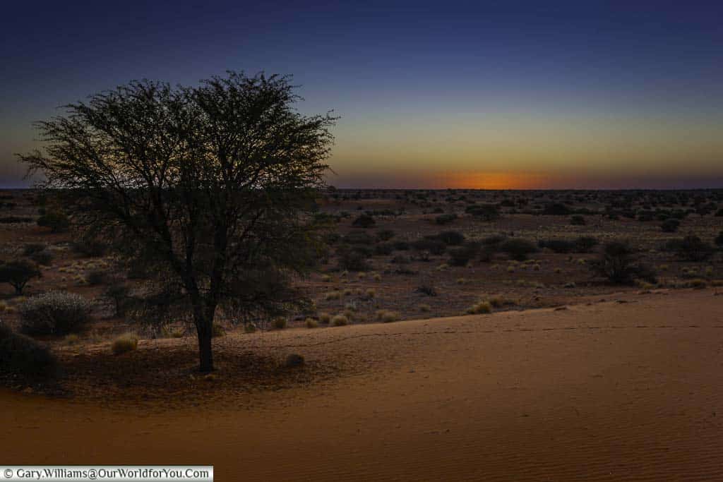 Sunset over the kalahari desert at the bagatelle kalahari game ranch in namibia as we enjoy sundowners
