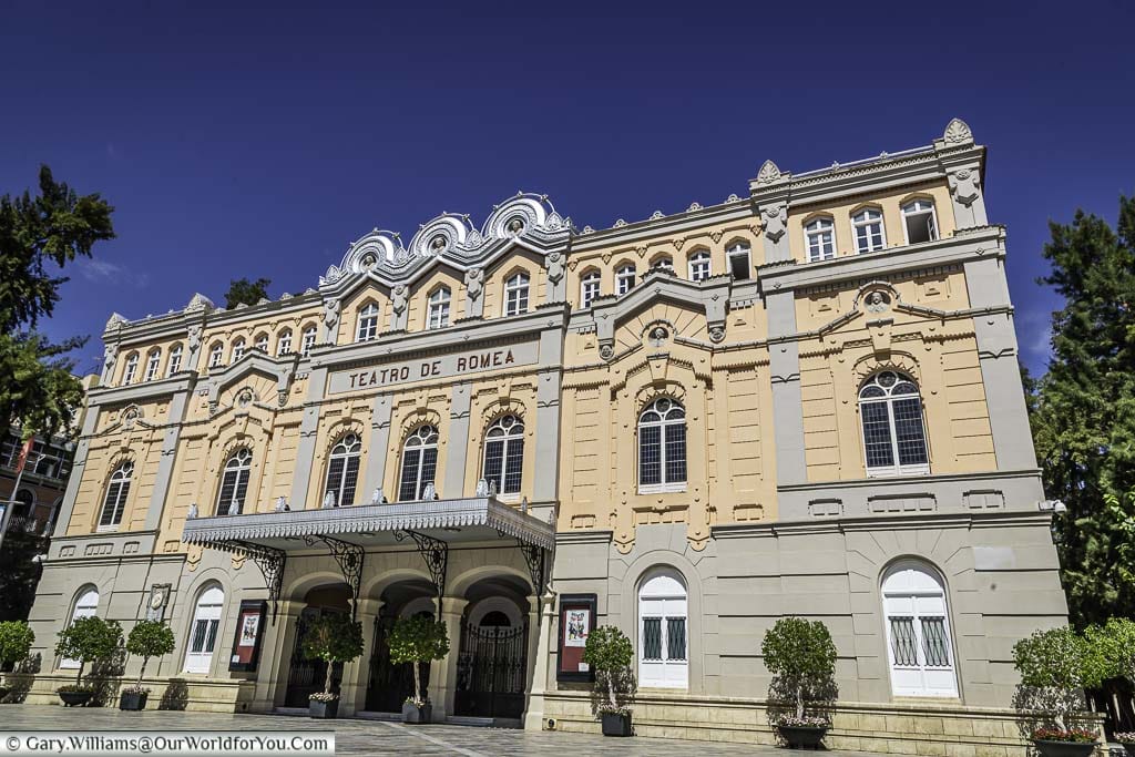The pink and grey art nouveau style, teatro de romea, a theatre building in Murcia, Spain, under a deep blue sky