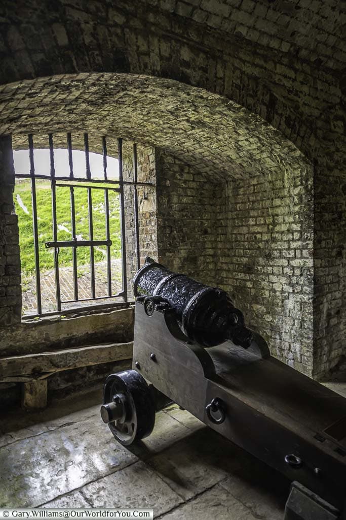A small iron canon from the napoleonic era on its gun carriage in place a window at dover castle in kent