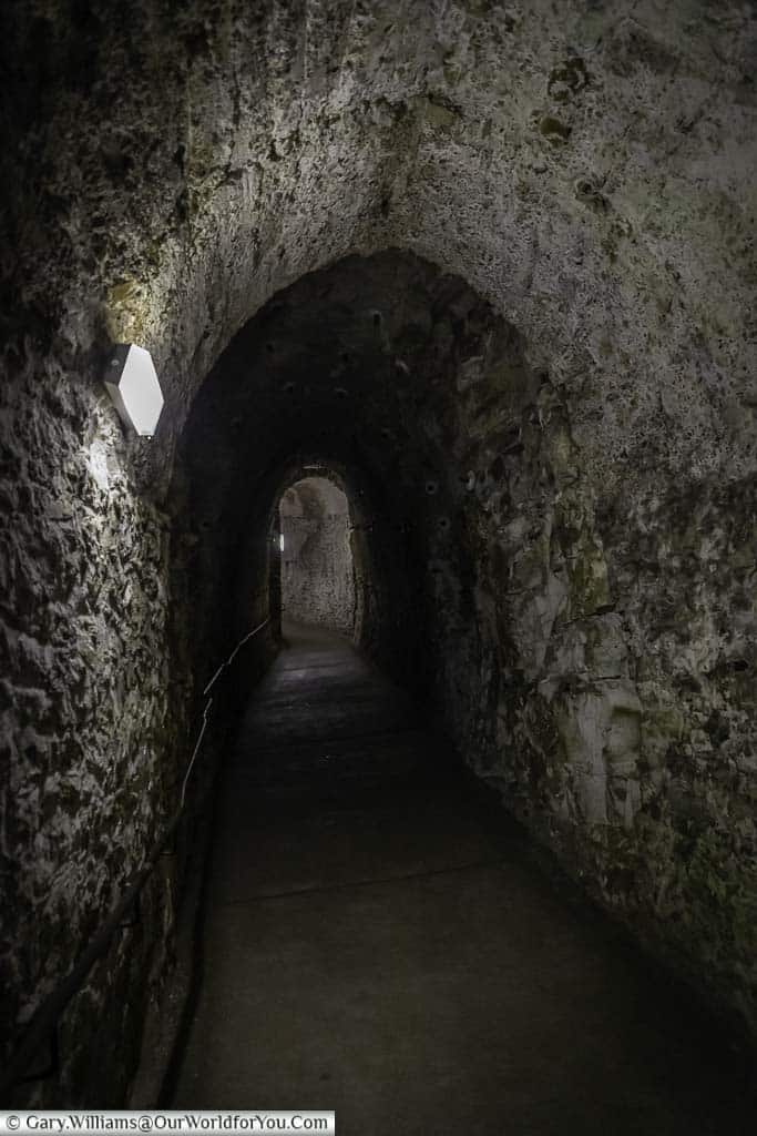 A dimly lit napoleonic tunnel carved into the chalk at dover castle in kent