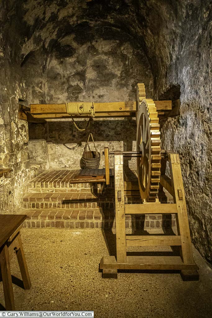 A wooden mechanism for lowering a bucket into dover castle keep's well.
