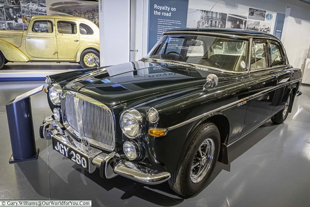A dark green, almost black, Rover P5B, from the late '60s/early '70s, on display at the British Motor Museum