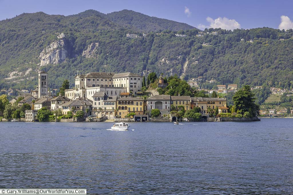 A boat returning from Isola San Giulio on Lake Orta where the convent and church dominate this historic little island. Again the backdrop is green mountains.