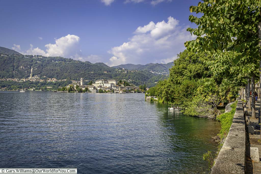 A view of Lake Orta from the tree lined path that leads into Orta San Giulio. In the distance you can see Isola San Giulio dwarfed by the hills that surround the lake.