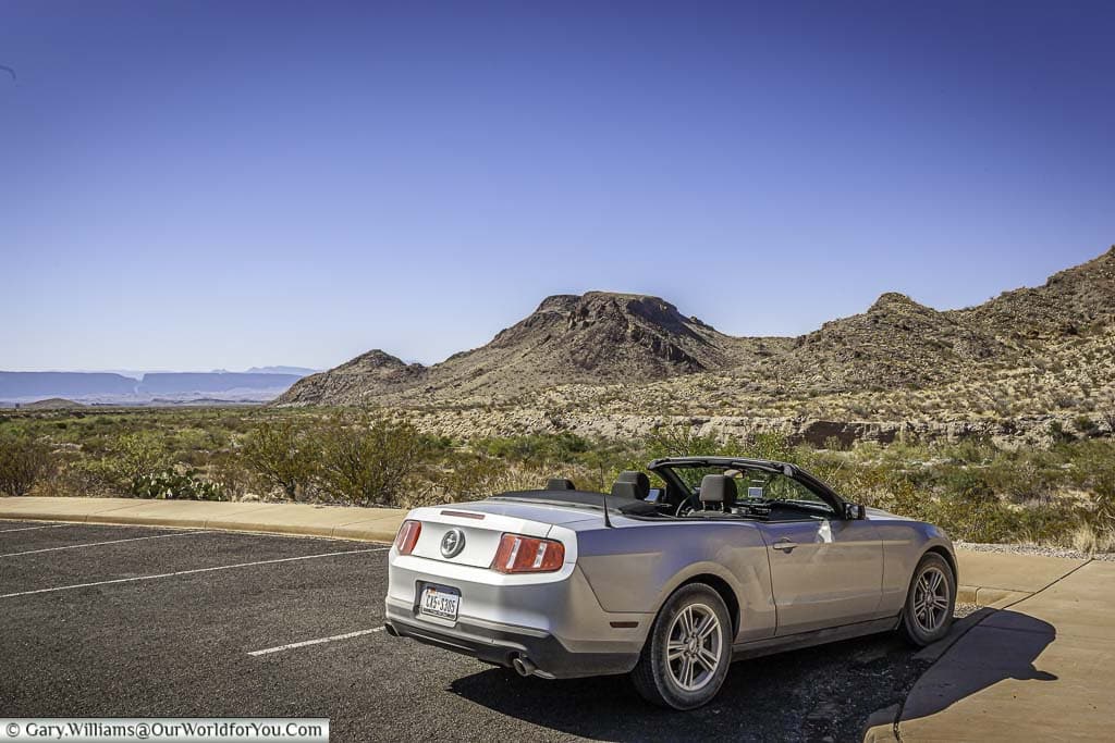 Our ford mustang convertible parked up in the big bend national park in Texas