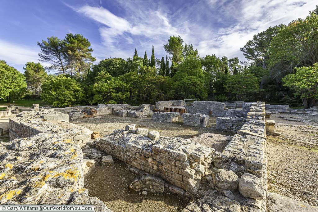 The low brick walls of the remains of the roman baths in the archaeological site of glanum, just outside Saint-Rémy-de-Provence, in the south of france
