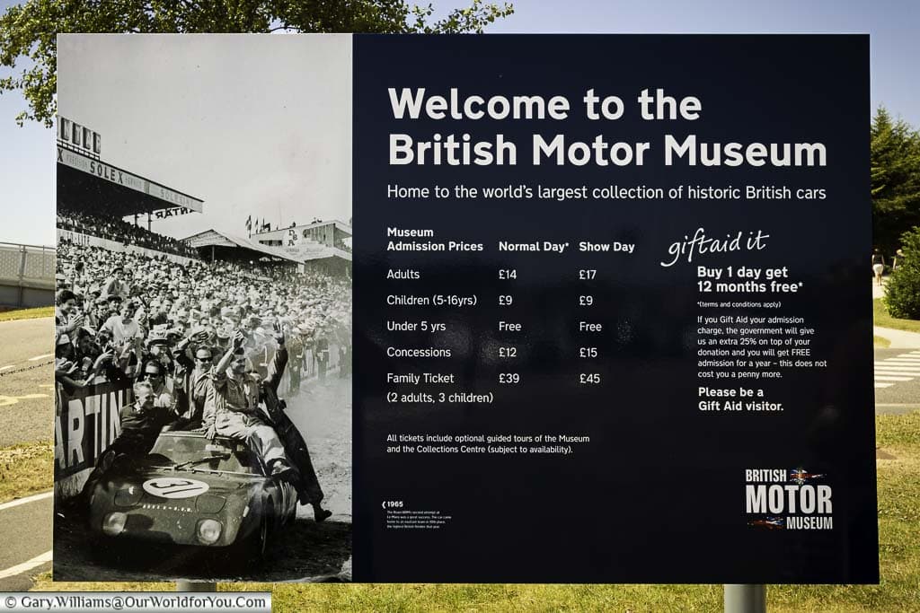 The welcome board to the British Motor Museum, detailing the prices from 2018, plus a scene from the fish of a historic race.