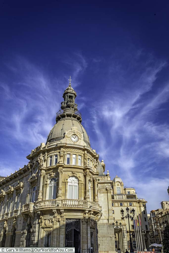 The classically styled cartagena city hall under deep blue skies in cartegena in southern spain