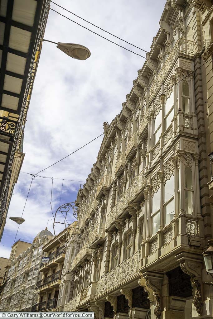 A cream-coloured ornate modernist facade of casa cervantes on calle mayor in cartagena in southern spain