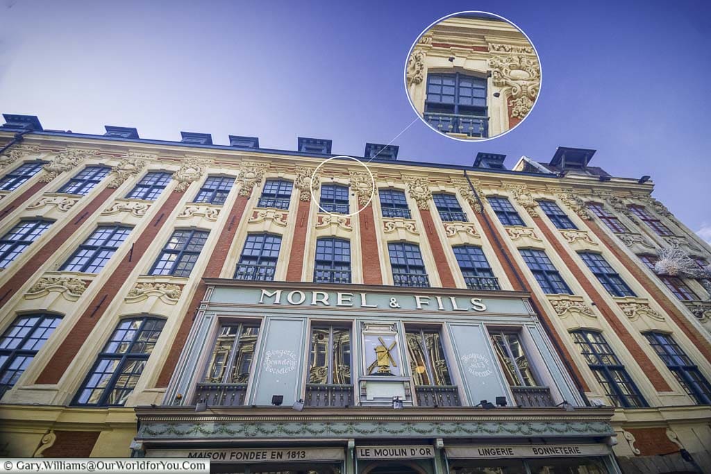 A shot of a building in Place du Théâtre, including the shop Morel & Fils, that still has the cannonballs lodge in the wall from the siege of Lille.